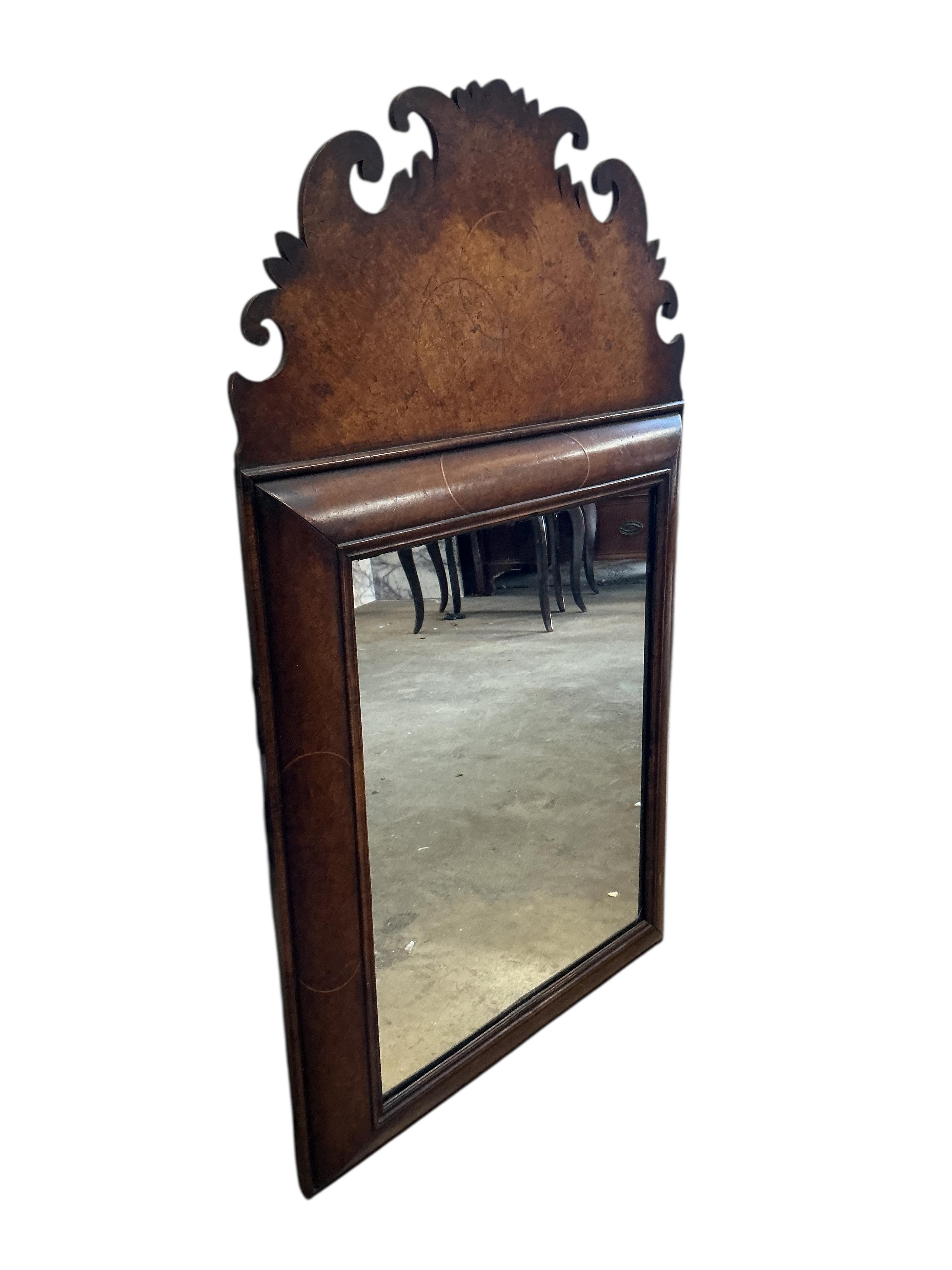 A William and Mary style walnut cushion framed fret cut wall mirror, width 56cm, height 96cm